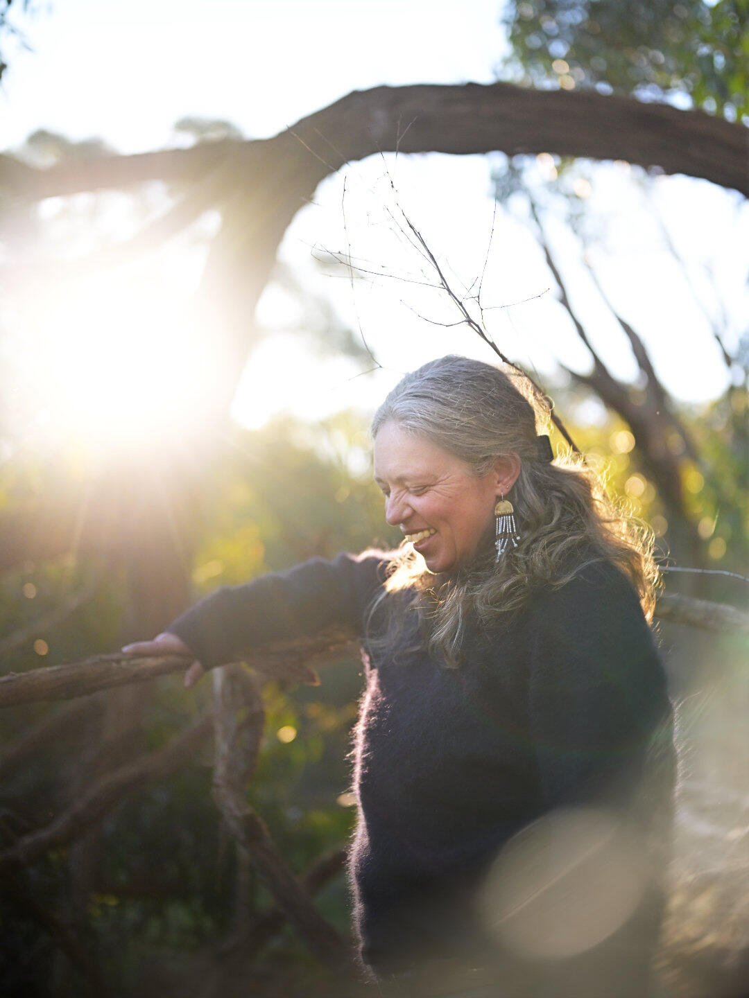 Rural Sunset Smile A beautiful capture of a mature woman's smile as the sun sets behind her. This portrait was captured at Woods Bushland Reserve in Tuerong on the Mornington Peninsula