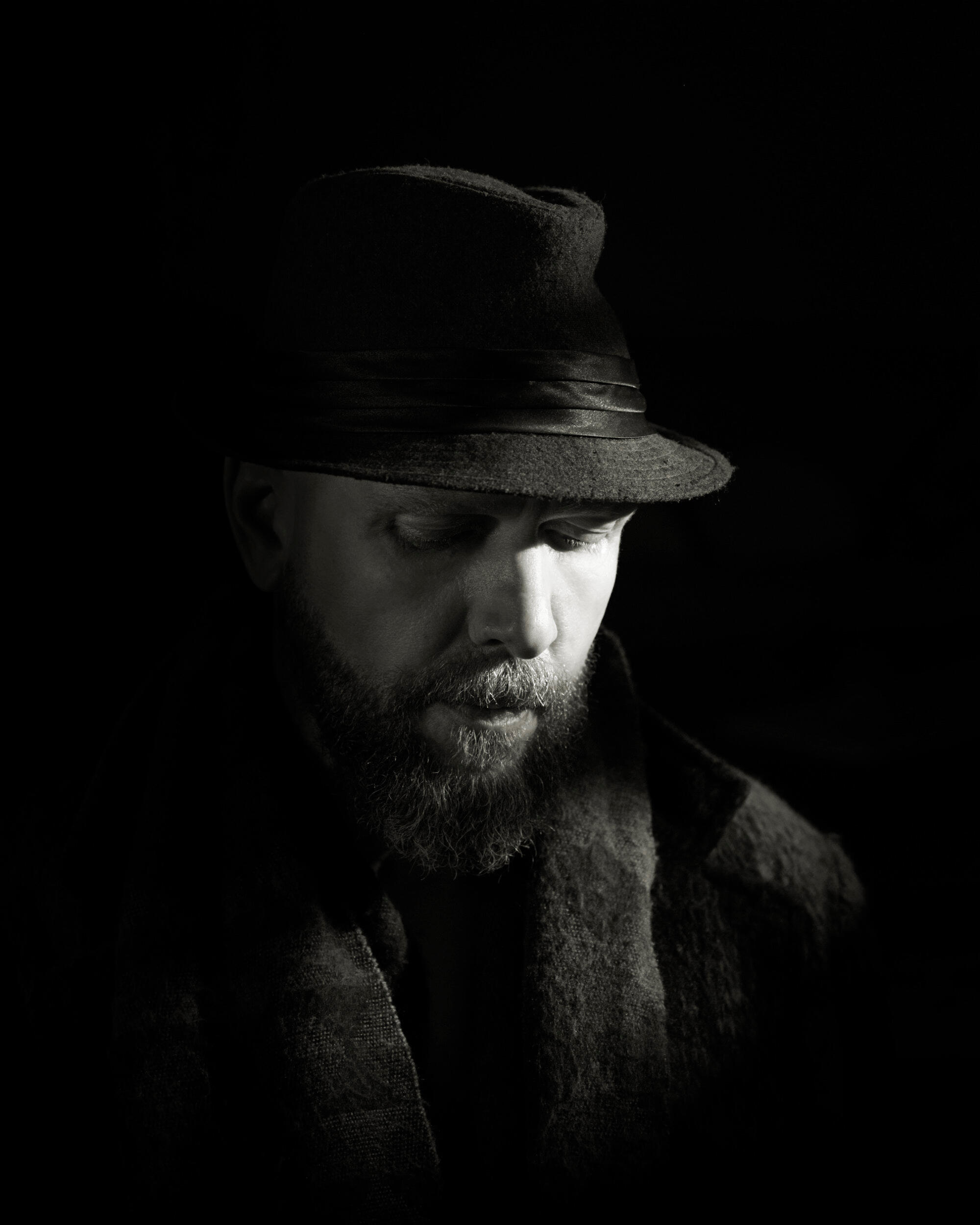 A man in deep consideration with soft expression. I love the lighting in this. It lends well to the black and white sepia cinematic tone. It evokes such sweet emotion