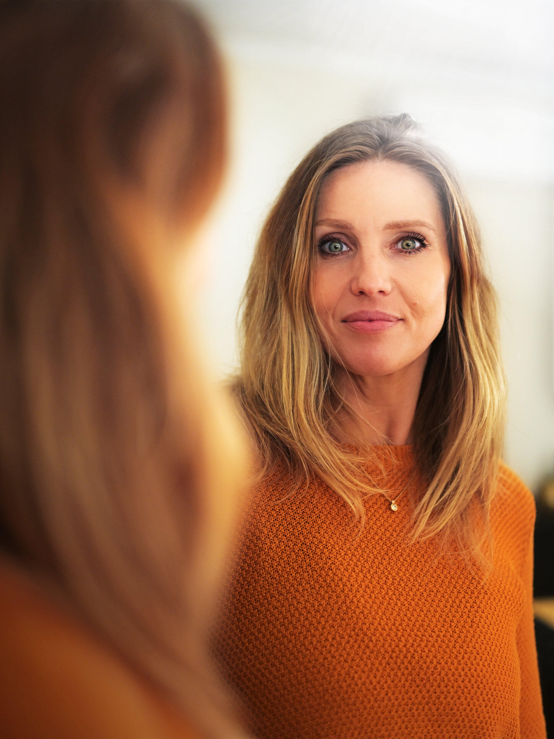 Mirror Beauty Portrait A beautiful woman in front of a mirror with piercing green eyes and a warm glow