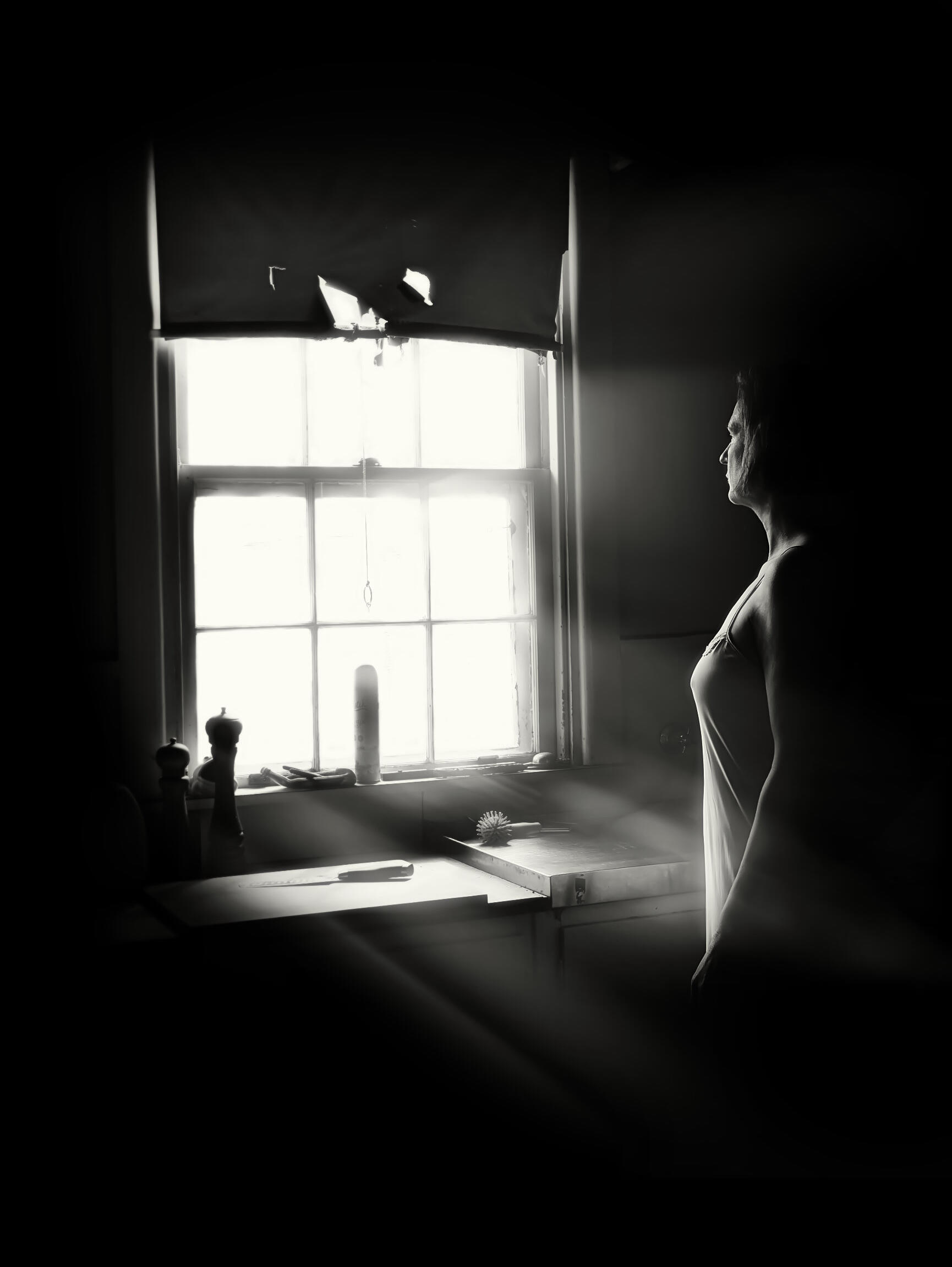 Found In Light. Black and white portrait of a woman lit by window light during a Found In Light photography session in Mount Eliza, Victoria.