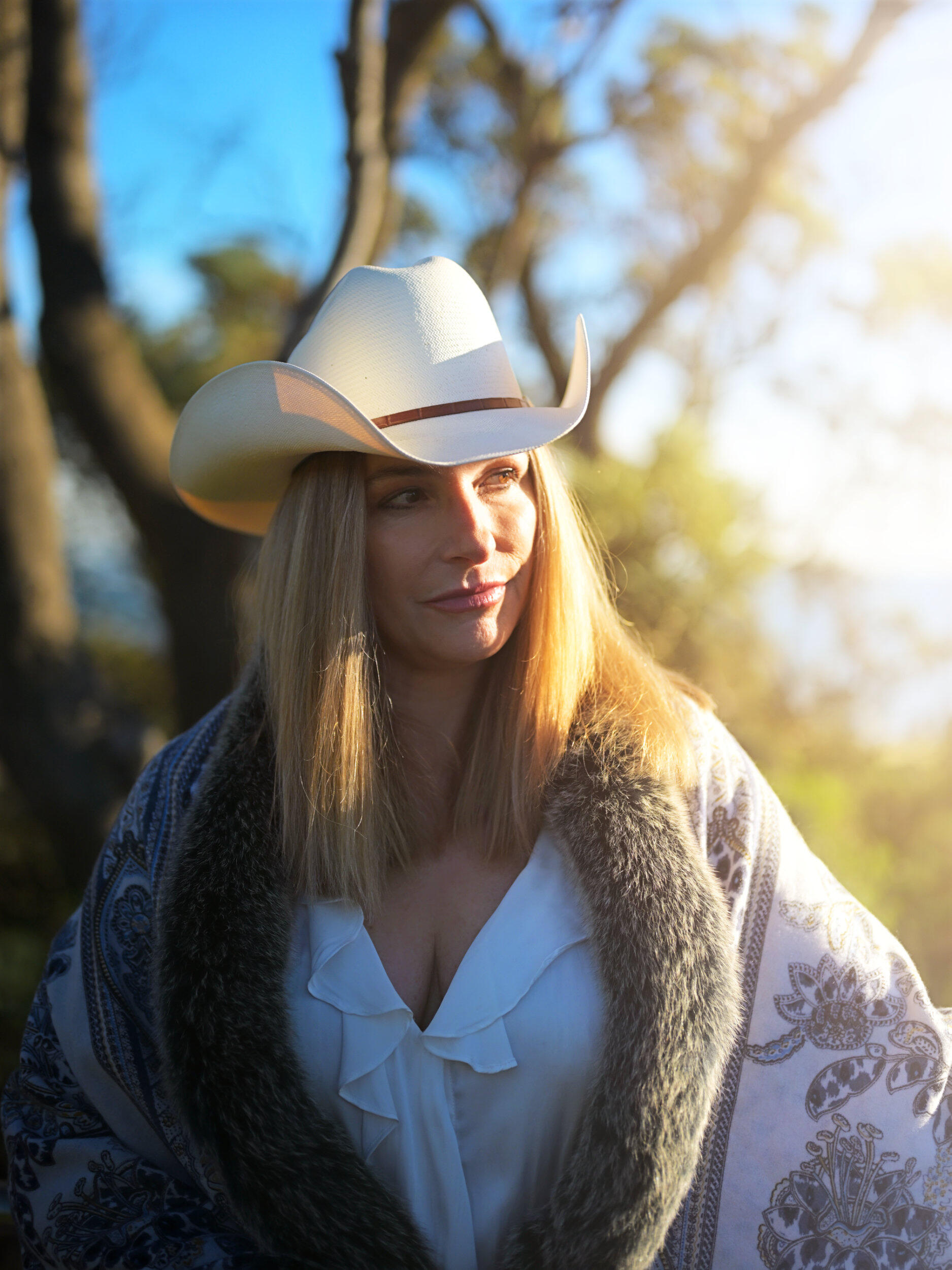 Shot at Frankston beach just before sunset. She wears a cowboy hat enjoying the warm sun in a Melbourne winter