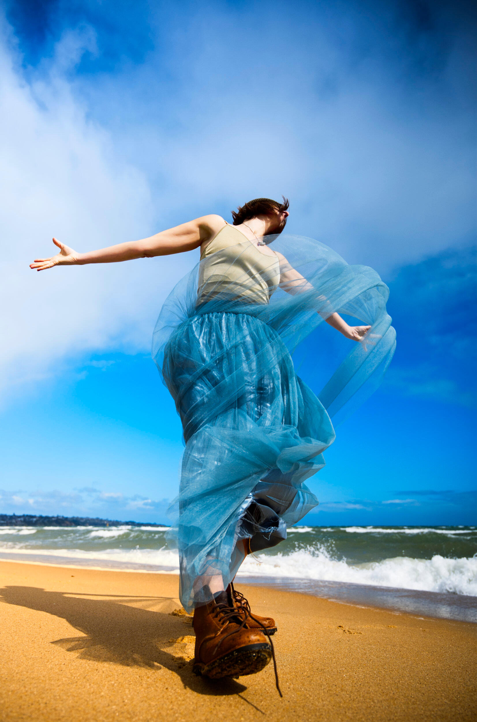 This is one of my more creative, fashion inspired portraits. A woman prancing a child like persona on a beach in Frankston, Victoria